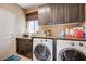 Functional laundry room with washer, dryer, and storage at 9729 Hawk Crest St, Las Vegas, NV 89141
