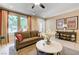 Cozy living room featuring a sofa, a marble table, and windows with natural lighting at 9729 Hawk Crest St, Las Vegas, NV 89141