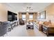 Cozy living room with comfortable seating, a ceiling fan, and natural light at 9729 Hawk Crest St, Las Vegas, NV 89141