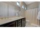 Bathroom featuring double sinks, quartz countertops, and tiled floors at 334 Cougar Estates Ln, Las Vegas, NV 89123