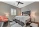 Cozy bedroom features a plush bed, stylish furnishings, and a ceiling fan at 334 Cougar Estates Ln, Las Vegas, NV 89123