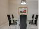 Dining area with a modern glass table and black chairs at 334 Cougar Estates Ln, Las Vegas, NV 89123