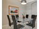 Dining room with black leather chairs, modern lighting, and tile floors at 334 Cougar Estates Ln, Las Vegas, NV 89123