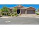 Charming home featuring a tile roof, stone accents, mature landscaping and a three-car garage at 334 Cougar Estates Ln, Las Vegas, NV 89123