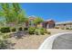 Inviting home with well-manicured landscaping, stone accents, and a three-car garage at 334 Cougar Estates Ln, Las Vegas, NV 89123