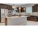 Gourmet kitchen with stainless steel appliances, granite countertops, and dark cabinets for a modern touch at 334 Cougar Estates Ln, Las Vegas, NV 89123