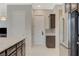 View of the open kitchen featuring granite counters, stainless steel refrigerator, and painted cabinets at 334 Cougar Estates Ln, Las Vegas, NV 89123