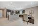 Open concept kitchen featuring stainless steel appliances and plenty of seating at the kitchen island at 334 Cougar Estates Ln, Las Vegas, NV 89123