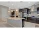 Bright open kitchen featuring stainless steel appliances, granite countertops, and modern lighting at 334 Cougar Estates Ln, Las Vegas, NV 89123