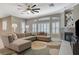 Bright living room featuring plantation shutters, fireplace, and a large sectional couch at 334 Cougar Estates Ln, Las Vegas, NV 89123