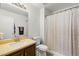 Bathroom featuring a shower and tub combination, toilet and brown vanity with light brown top at 10253 Martinsburg Ct, Las Vegas, NV 89183