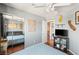 Bedroom with wood floors and light gray walls featuring a mirrored closet and view of the laundry area at 10253 Martinsburg Ct, Las Vegas, NV 89183