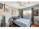 Well decorated bedroom with wood floors featuring a bed, art, memorabilia and a flat screen TV at 10253 Martinsburg Ct, Las Vegas, NV 89183