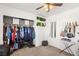 Walk in closet featuring shelves with folded boxes, colorful clothes, belts and purses hanging on the wall at 10253 Martinsburg Ct, Las Vegas, NV 89183