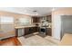 Well-lit kitchen with stainless steel appliances, mosaic backsplash, and wood-look flooring at 10253 Martinsburg Ct, Las Vegas, NV 89183