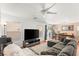 Spacious living room featuring a large sectional couch and a mounted television at 10253 Martinsburg Ct, Las Vegas, NV 89183