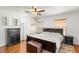 Spacious main bedroom with wood floors, a ceiling fan, and ample natural light at 10253 Martinsburg Ct, Las Vegas, NV 89183