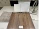 Selection of carpet, plank flooring, cabinetry, countertop, and fixtures for a cohesive design at 10283 Water Knot Ave, Las Vegas, NV 89166