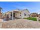 Beautiful backyard with covered patio, pavers, and artificial grass at 10613 Tiffanieville Ct, Las Vegas, NV 89129