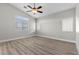 Spacious bedroom with wood-style flooring, ceiling fan and natural light at 10613 Tiffanieville Ct, Las Vegas, NV 89129