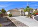 Attractive single story home featuring a two car garage and desert landscaping at 10613 Tiffanieville Ct, Las Vegas, NV 89129