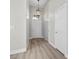 Inviting hallway features wood-style flooring and contemporary light fixture at 10613 Tiffanieville Ct, Las Vegas, NV 89129