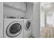 Laundry room with modern washer and dryer units and storage space at 10613 Tiffanieville Ct, Las Vegas, NV 89129