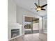 Living room with a fireplace, sliding glass door access to the patio, and modern flooring at 10613 Tiffanieville Ct, Las Vegas, NV 89129