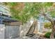 View of building exterior with tree cover and staircase at 1101 Willow Tree Dr # D, Las Vegas, NV 89128