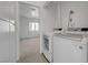 Convenient laundry room with modern appliances and space for storage, adjacent to another room at 1101 Willow Tree Dr # D, Las Vegas, NV 89128