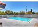 Community pool with clear blue water, surrounded by lush greenery and seating areas at 1101 Willow Tree Dr # D, Las Vegas, NV 89128