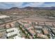 Aerial shot of community featuring many residential homes, apartments, roadways, and distant mountain views at 1425 Overseer Ave, Henderson, NV 89074