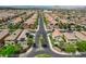 An aerial view of a residential area with neat houses featuring well-maintained streets and palm trees at 1425 Overseer Ave, Henderson, NV 89074