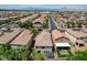 A backyard with a covered patio, a small seating area, artificial grass, and a view of the surrounding neighborhood at 1425 Overseer Ave, Henderson, NV 89074
