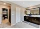 Spacious bathroom with double vanity, tile flooring, and walk-in closet entrance at 1425 Overseer Ave, Henderson, NV 89074