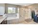 Bathroom featuring a soaking tub, walk-in shower, and a double vanity with modern finishes at 1425 Overseer Ave, Henderson, NV 89074