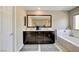 Bathroom with double sink vanity, soaking tub, and natural light from a window at 1425 Overseer Ave, Henderson, NV 89074
