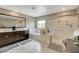 Bright bathroom featuring a double vanity, soaking tub, and glass-enclosed shower at 1425 Overseer Ave, Henderson, NV 89074