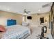 Bright bedroom with a ceiling fan, TV, and adjacent room through an open doorway at 1425 Overseer Ave, Henderson, NV 89074
