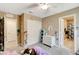 Neutral bedroom with closet, adjacent bath, and playful Toy Story themed wall decorations at 1425 Overseer Ave, Henderson, NV 89074