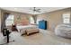 Spacious bedroom featuring a king-sized bed, a ceiling fan and two windows with natural light at 1425 Overseer Ave, Henderson, NV 89074
