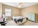 Cozy bedroom with window, ceiling fan, and classic mint-colored dresser at 1425 Overseer Ave, Henderson, NV 89074