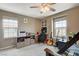 Bedroom with a bunk bed, desk, guitars, ceiling fan, and window to the backyard at 1425 Overseer Ave, Henderson, NV 89074