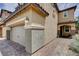 Side view of a charming two-story home with a two-car garage and sidewalk at 1425 Overseer Ave, Henderson, NV 89074