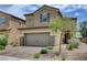 Attractive two-story home with a two-car garage and tidy landscaping under a bright sky at 1425 Overseer Ave, Henderson, NV 89074