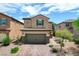 Two-story home with a tiled roof, two car garage, and a brick paver driveway at 1425 Overseer Ave, Henderson, NV 89074