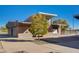 Exterior view of a modern community building surrounded by landscaping and a tree, featuring a covered walkway at 1425 Overseer Ave, Henderson, NV 89074