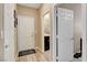 Hallway featuring multiple white paneled doors and durable flooring with a view of the bathroom at 1425 Overseer Ave, Henderson, NV 89074