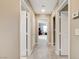Neutral hallway with multiple white doors and light gray carpeting at 1425 Overseer Ave, Henderson, NV 89074