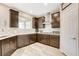 Stylish kitchen featuring dark wood cabinets, white countertops, stainless steel appliances, and mosaic tile backsplash at 1425 Overseer Ave, Henderson, NV 89074